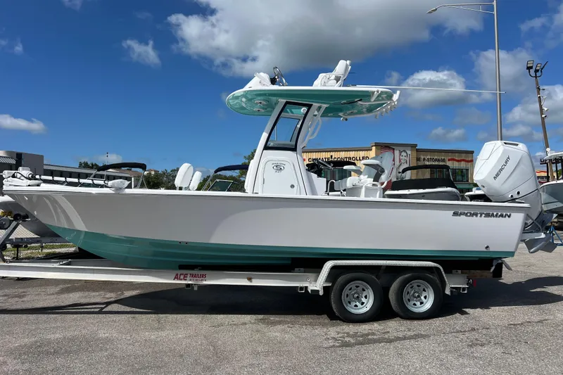 Slide: The Image of 2026 Sportsman Masters 247 Bay Boat on trailer, under clear blue sky. - 2