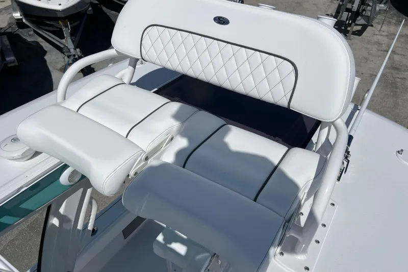 Slide: The Image of 2026 Sportsman Masters 247 Bay Boat with white cushioned seating and sleek design. - 20