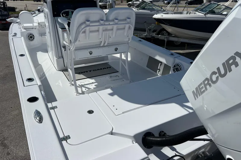 Slide: The Image of 2026 Sportsman Masters 247 Bay Boat with Mercury engine, featuring spacious deck and seating. - 6