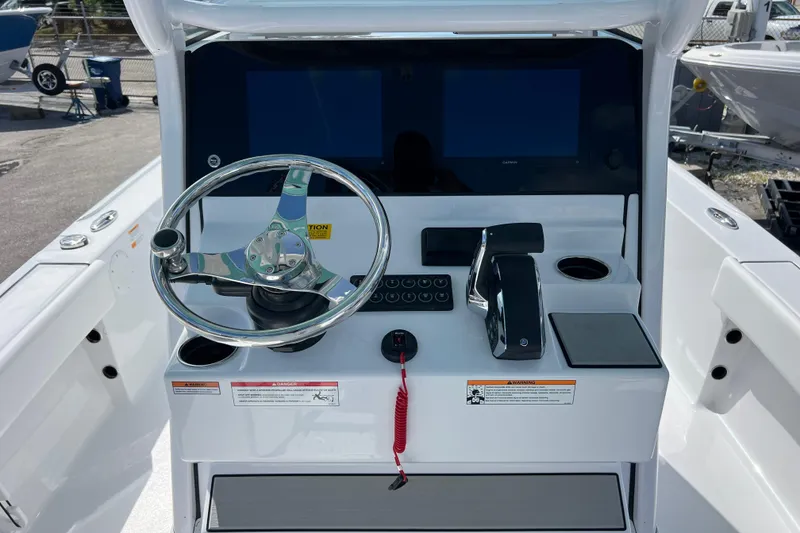 Slide: The Image of 2026 Sportsman Masters 247 Bay Boat helm with steering wheel and control panel. - 9