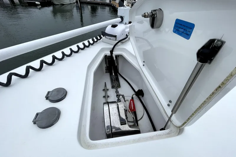 Slide: The Image of Anchor compartment of 2021 Sea Hunt Gamefish 27 Forward Seating boat at marina. - 10