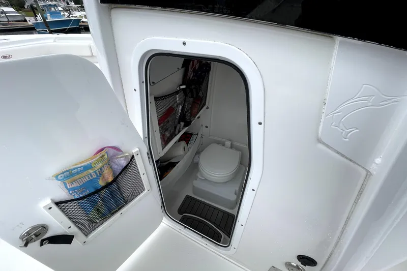 Slide: The Image of 2021 Sea Hunt Gamefish 27 boat interior with compact marine toilet. - 12