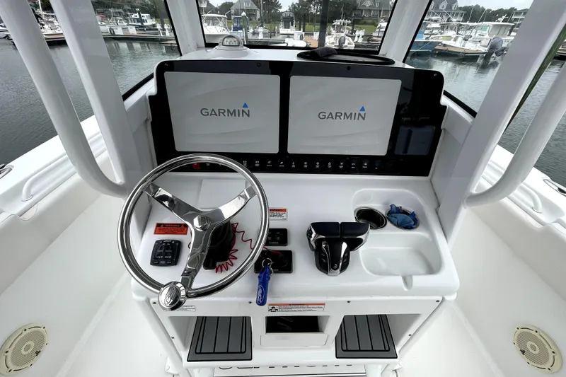 Slide: The Image of 2021 Sea Hunt Gamefish 27 helm with Garmin displays and steering wheel. - 14