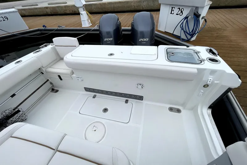 Slide: The Image of 2021 Sea Hunt Gamefish 27 boat with dual Yamaha 200 engines, docked at marina. - 21