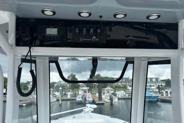 Slide: The Image of 2021 Sea Hunt Gamefish 27 boat docked in a marina, overcast sky. - 4