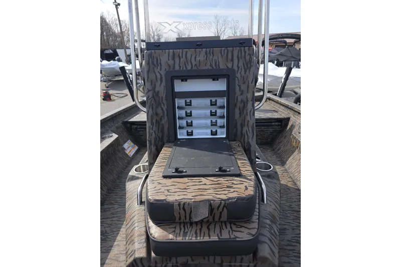 Slide: The Image of 2026 Xpress H20B Bay boat with camo seating and storage compartments. - 14