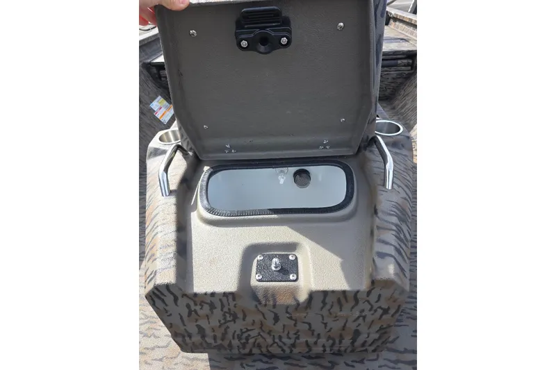 Slide: The Image of Open storage compartment in 2026 Xpress H20B Bay boat, featuring camouflage design. - 15