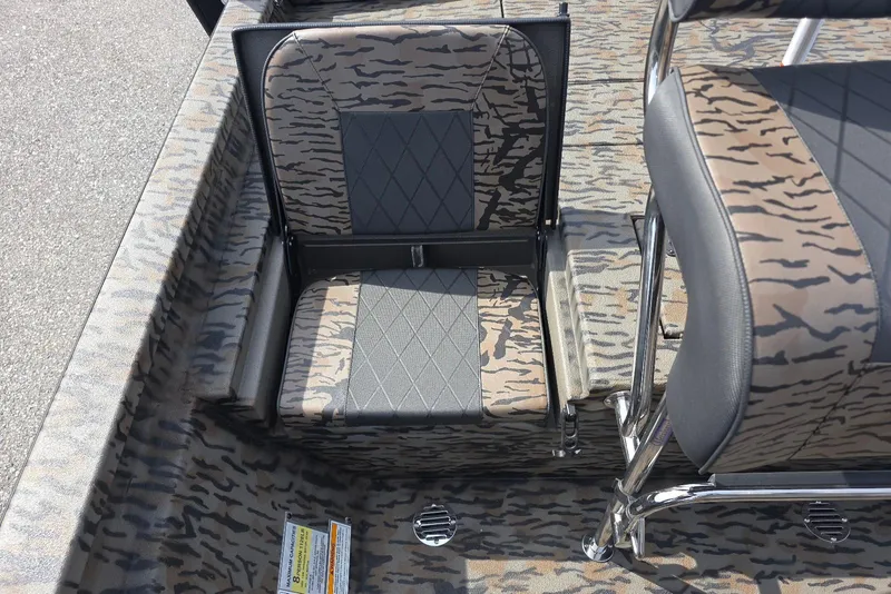 Slide: The Image of 2026 Xpress H20B Bay boat interior with camouflage seating and diamond-patterned upholstery. - 21