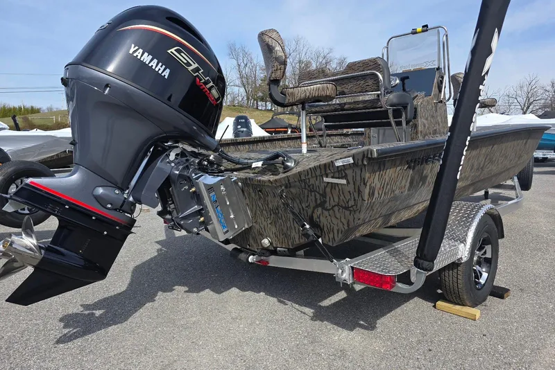Slide: The Image of 2026 Xpress H20B Bay boat with Yamaha engine on a trailer, parked outdoors. - 5