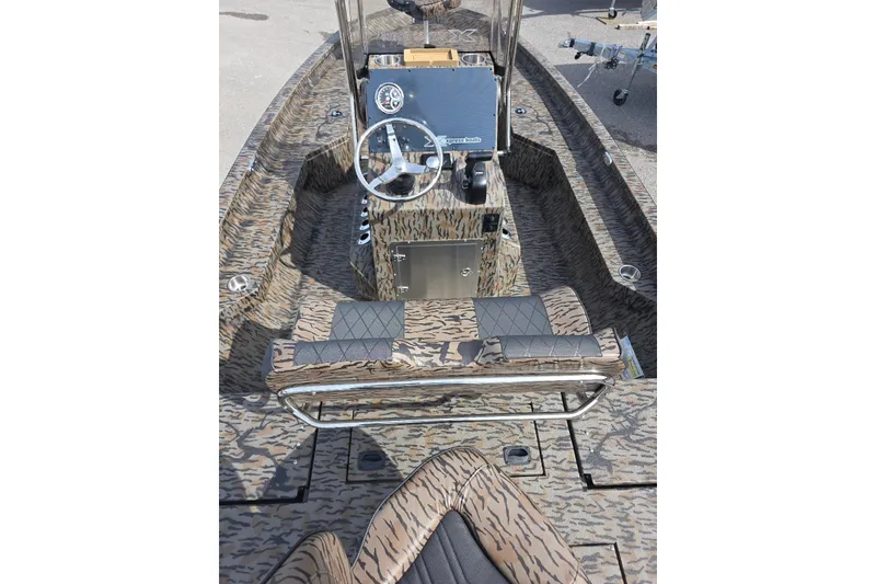 Slide: The Image of 2026 Xpress H20B Bay boat interior with camouflage design and steering console. - 8