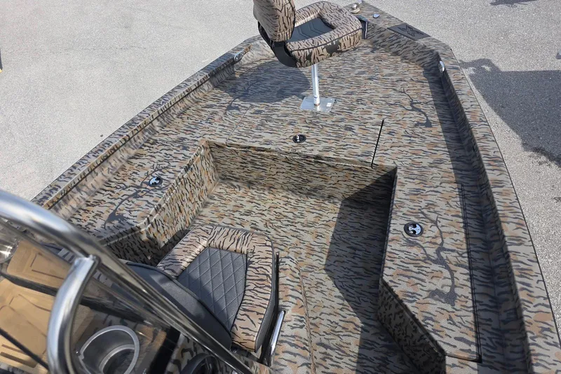 Slide: The Image of 2026 Xpress H20B Bay boat interior with camouflage design and seating. - 9