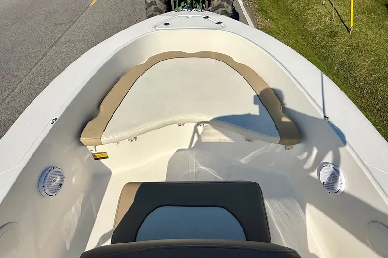 Slide: The Image of 2020 Pioneer 180 Sportfish boat interior with seating and speakers, parked on roadside. - 12