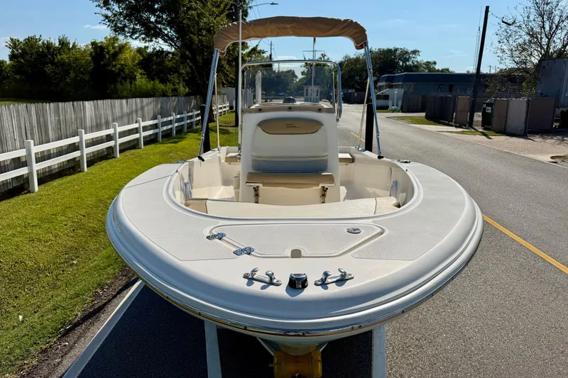 Slide: The Image of 2020 Pioneer 180 Sportfish boat on road, featuring sleek design and bimini top. - 6