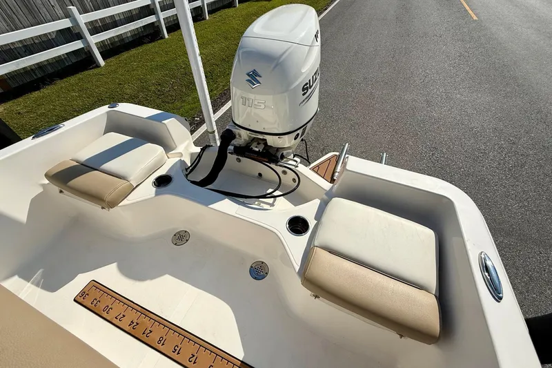 Slide: The Image of 2020 Pioneer 180 Sportfish boat with Suzuki 115 outboard motor, featuring cushioned seating. - 7