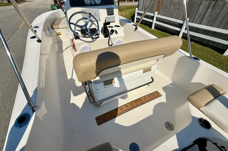 Slide: The Image of 2020 Pioneer 180 Sportfish boat interior with beige seating and steering console. - 8