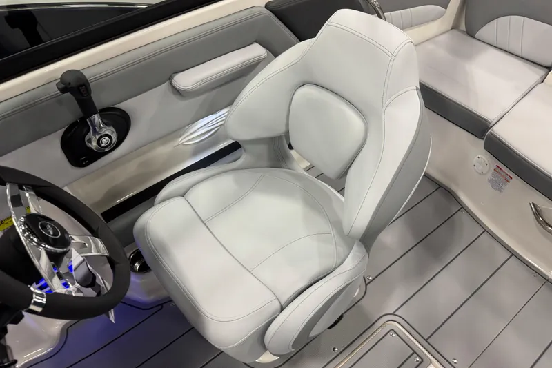 Slide: The Image of 2026 Chaparral 21 SSi boat interior with sleek white seating and modern steering wheel. - 11