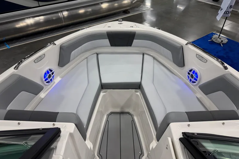 Slide: The Image of 2026 Chaparral 21 SSi boat interior with gray seating and blue LED lights. - 17