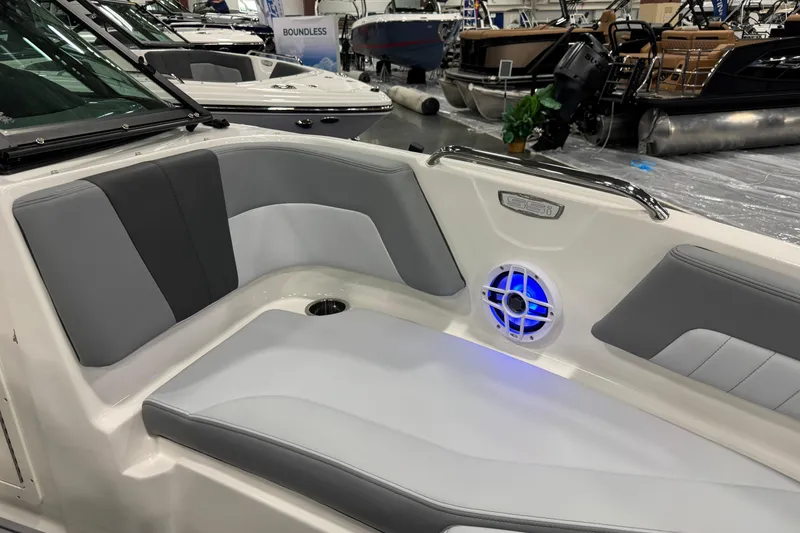 Slide: The Image of Interior of 2026 Chaparral 21 SSi boat with gray seating and blue-lit speaker. - 18