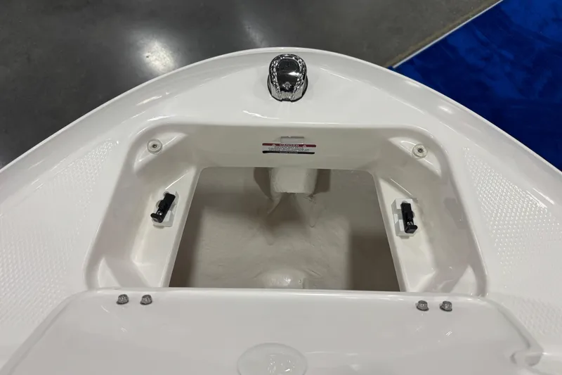 Slide: The Image of 2026 Chaparral 21 SSi boat storage compartment, white interior, open lid view. - 19