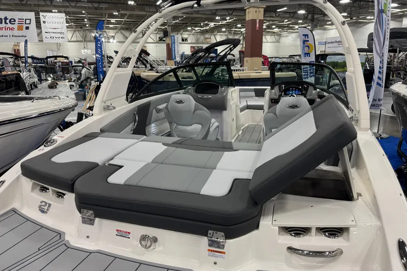 Slide: The Image of 2026 Chaparral 21 SSi boat interior at a boat show, featuring sleek seating and modern design. - 27
