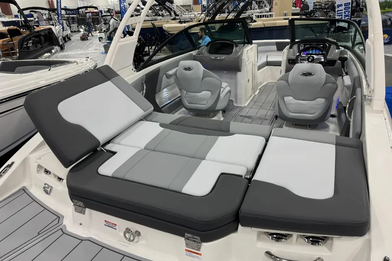 Slide: The Image of 2026 Chaparral 21 SSi boat interior with gray seating and modern dashboard. - 28