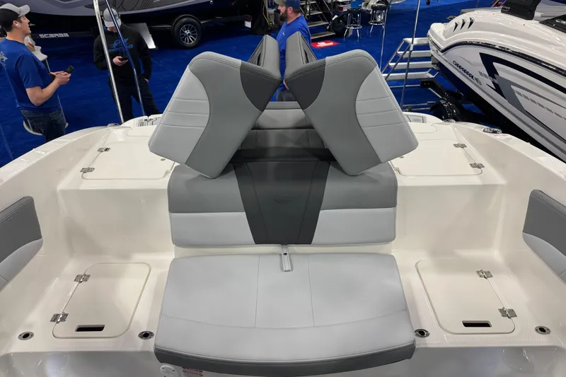 Slide: The Image of 2026 Chaparral 21 SSi boat interior with gray and white seating at a boat show. - 30