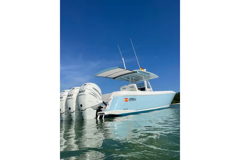 The Image of 2020 Intrepid 375 Nomad FE boat with triple engines on clear water. - 0