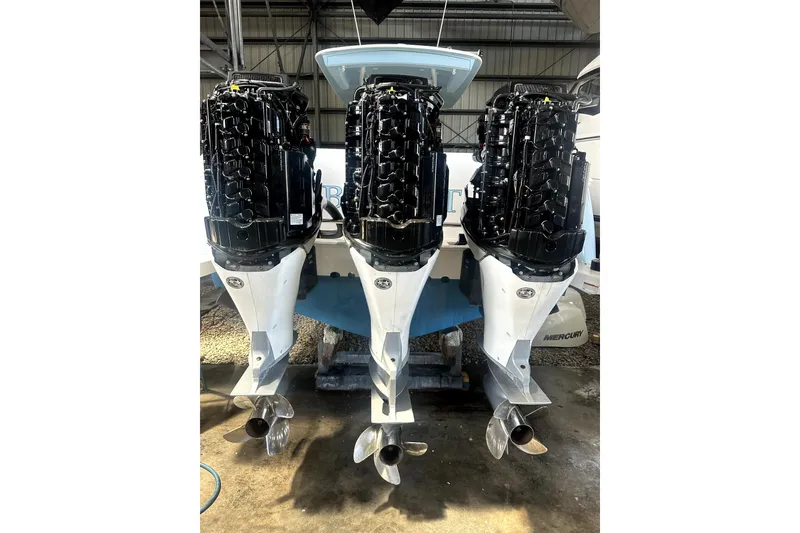 Slide: The Image of Triple outboard engines on a 2020 Intrepid 375 Nomad FE boat in a marina. - 10