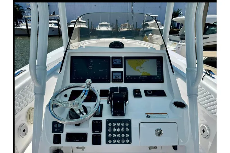 Slide: The Image of 2020 Intrepid 375 Nomad FE boat dashboard with navigation screens and controls. - 5