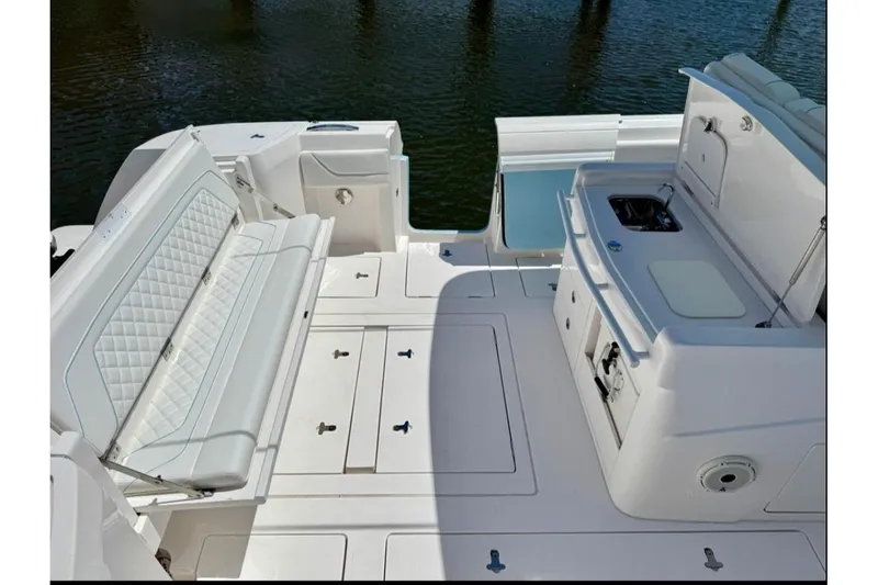 Slide: The Image of 2020 Intrepid 375 Nomad FE boat with triple Mercury engines docked at marina. - 6