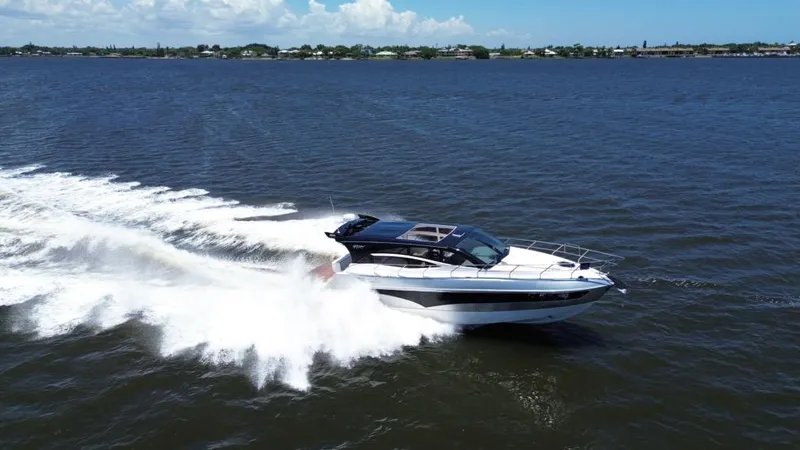 Slide: The Image of 2025 Real 40 HT Luxury yacht cruising on open water, creating a dynamic wake. - 12