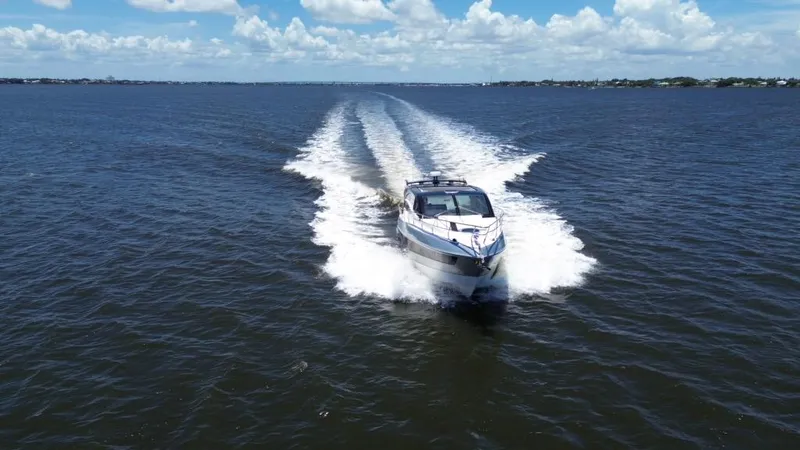 Slide: The Image of Luxury yacht Real 40 HT 2025 cruising on open water under blue skies. - 13