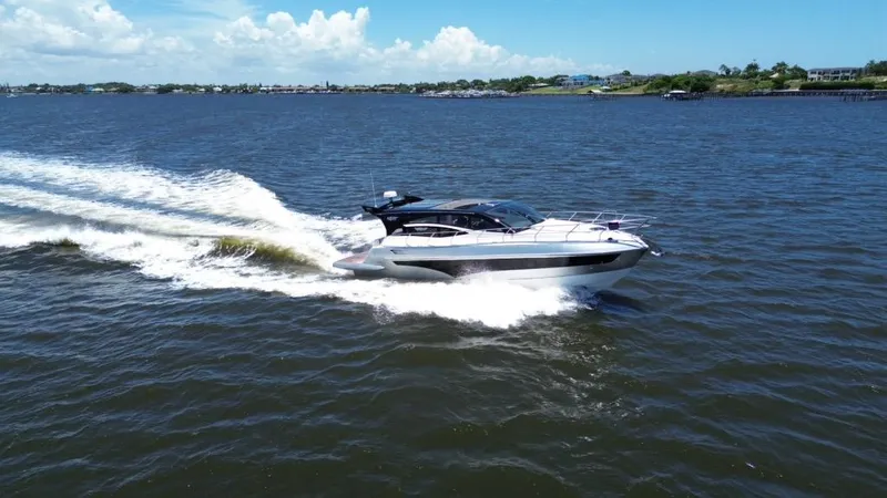 Slide: The Image of Luxury yacht Real 40 HT 2025 cruising on open water under clear skies. - 14