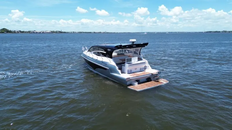 Slide: The Image of Luxury yacht Real 40 HT 2025 cruising on open water under a clear blue sky. - 20