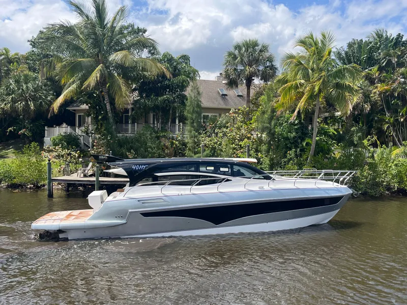 Slide: The Image of 2025 Real 40 HT Luxury yacht cruising on a tropical river with lush greenery. - 21