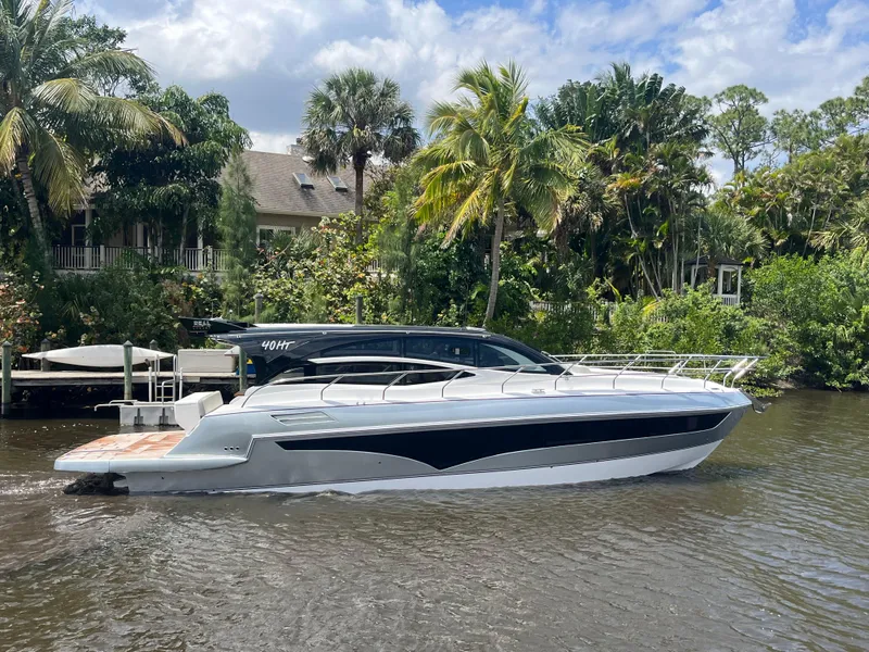 Slide: The Image of 2025 Real 40 HT Luxury yacht cruising on a scenic river with lush greenery. - 22