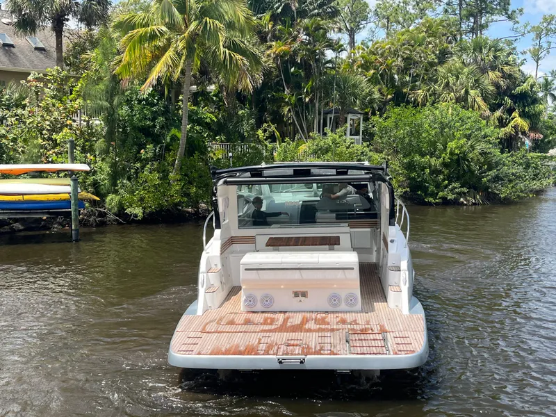 Slide: The Image of 2025 Real 40 HT Luxury boat cruising on a scenic river with lush greenery. - 26