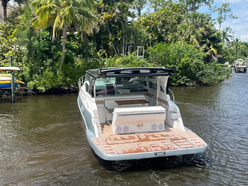 Slide: The Image of Luxury 2025 Real 40 HT boat on a serene river, surrounded by lush greenery. - 27