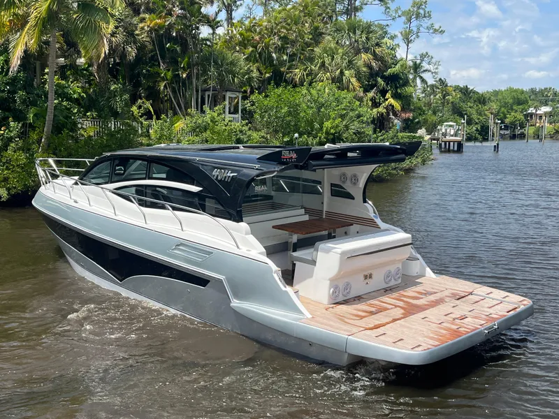 Slide: The Image of Luxury Real 40 HT yacht cruising on a scenic river, surrounded by lush greenery. - 28