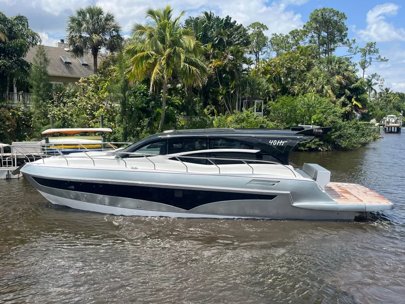 Slide: The Image of 2025 Real 40 HT Luxury yacht on a river, surrounded by lush greenery and palm trees. - 29