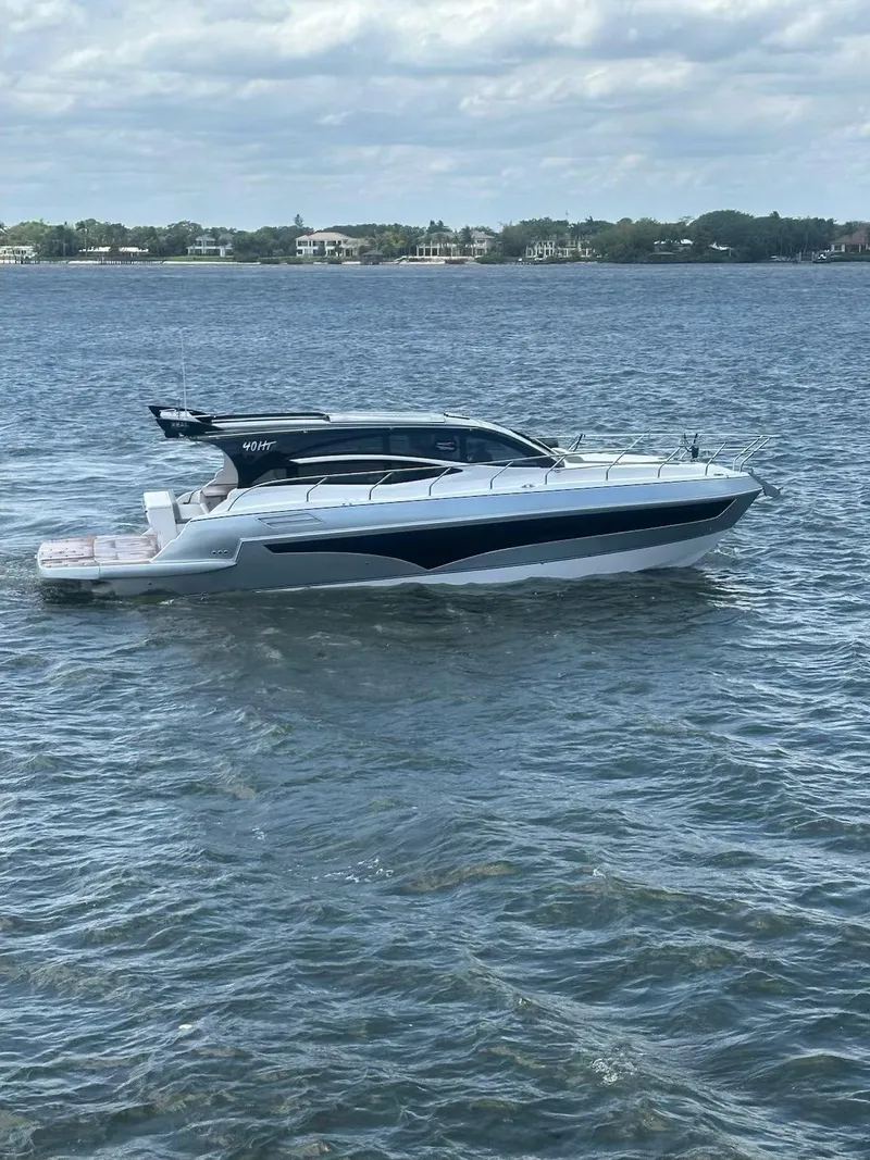 Slide: The Image of 2025 Real 40 HT Luxury yacht cruising on a calm sea under a cloudy sky. - 32