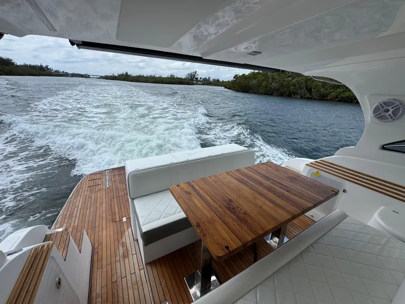 Slide: The Image of Luxurious 2025 Real 40 HT yacht interior with wooden table, cruising on a scenic waterway. - 37