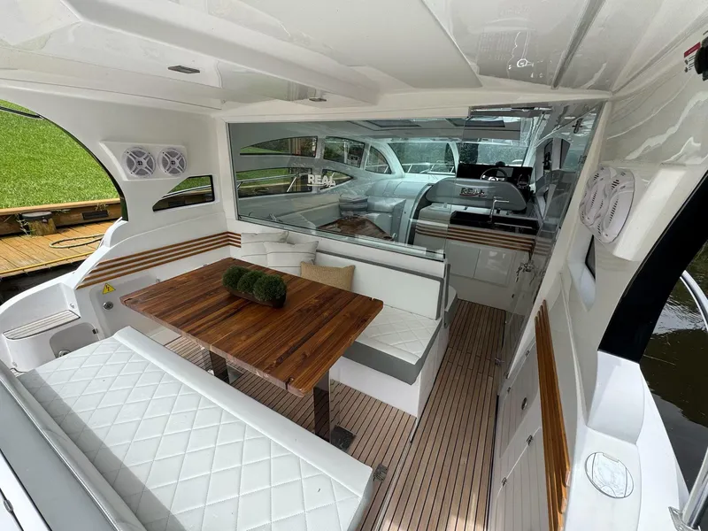 Slide: The Image of 2025 Real 40 HT Luxury yacht interior with elegant seating and wooden table. - 38