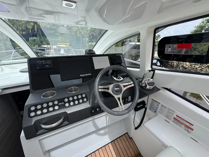 Slide: The Image of 2025 Real 40 HT Luxury yacht cockpit with modern steering and navigation controls. - 40