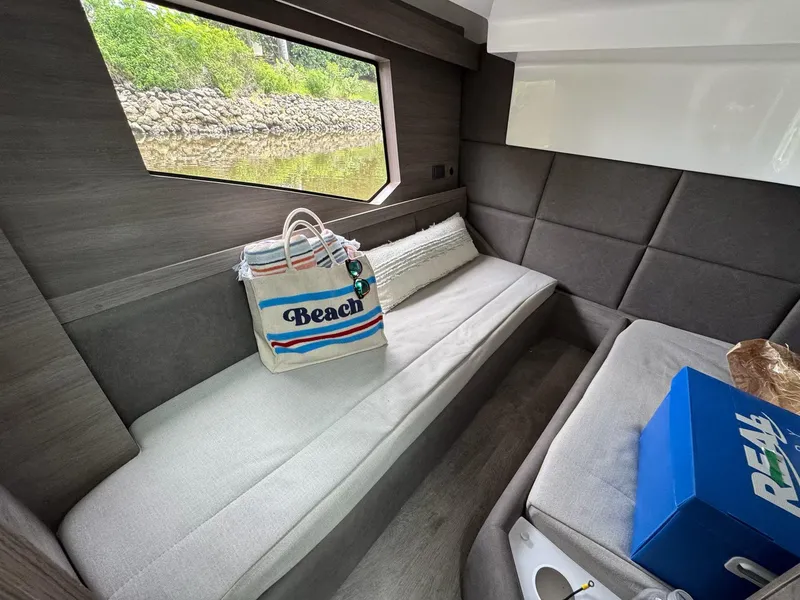 Slide: The Image of Interior of 2025 Real 40 HT Luxury yacht with beach bag and window view. - 42