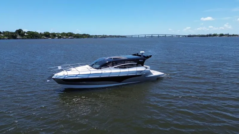 Slide: The Image of 2025 Real 40 HT Luxury yacht cruising on a calm river under a clear blue sky. - 5