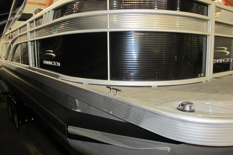 Slide: The Image of 2022 Bennington SX 22 Fishing pontoon boat, sleek design, black and silver exterior. - 0
