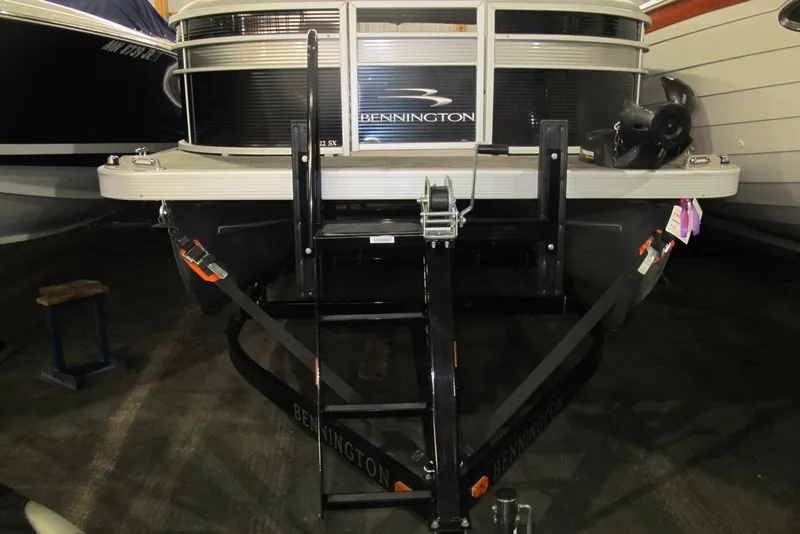 Slide: The Image of 2022 Bennington SX 22 Fishing boat on trailer in storage facility. - 2
