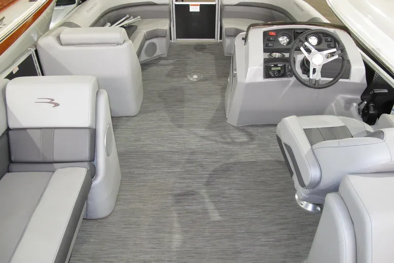 Slide: The Image of 2022 Bennington SX 22 Fishing boat interior with gray seating and modern dashboard. - 5