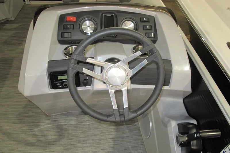 Slide: The Image of 2022 Bennington SX 22 Fishing boat dashboard with steering wheel and controls. - 7